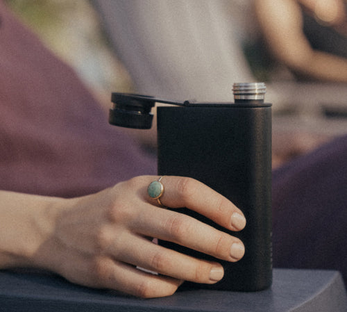 A hand holding the MiiR Aero Flask