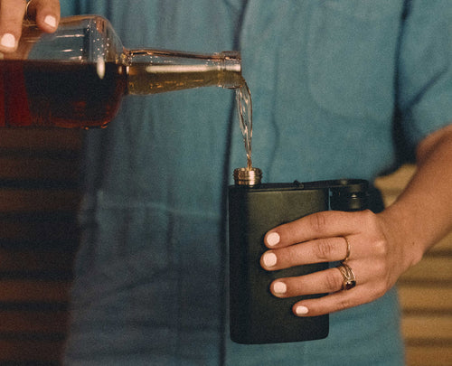 Pouring a spirit into the MiiR Aero Flask