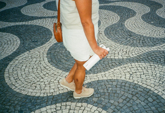 Person holding a MiiR Chug Bottle while walking