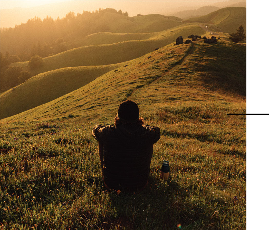 Man in a field with a MiiR bottle